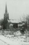 View of St Mary's Church, Upton, December 1978. View across the graveyard, covered in snow.